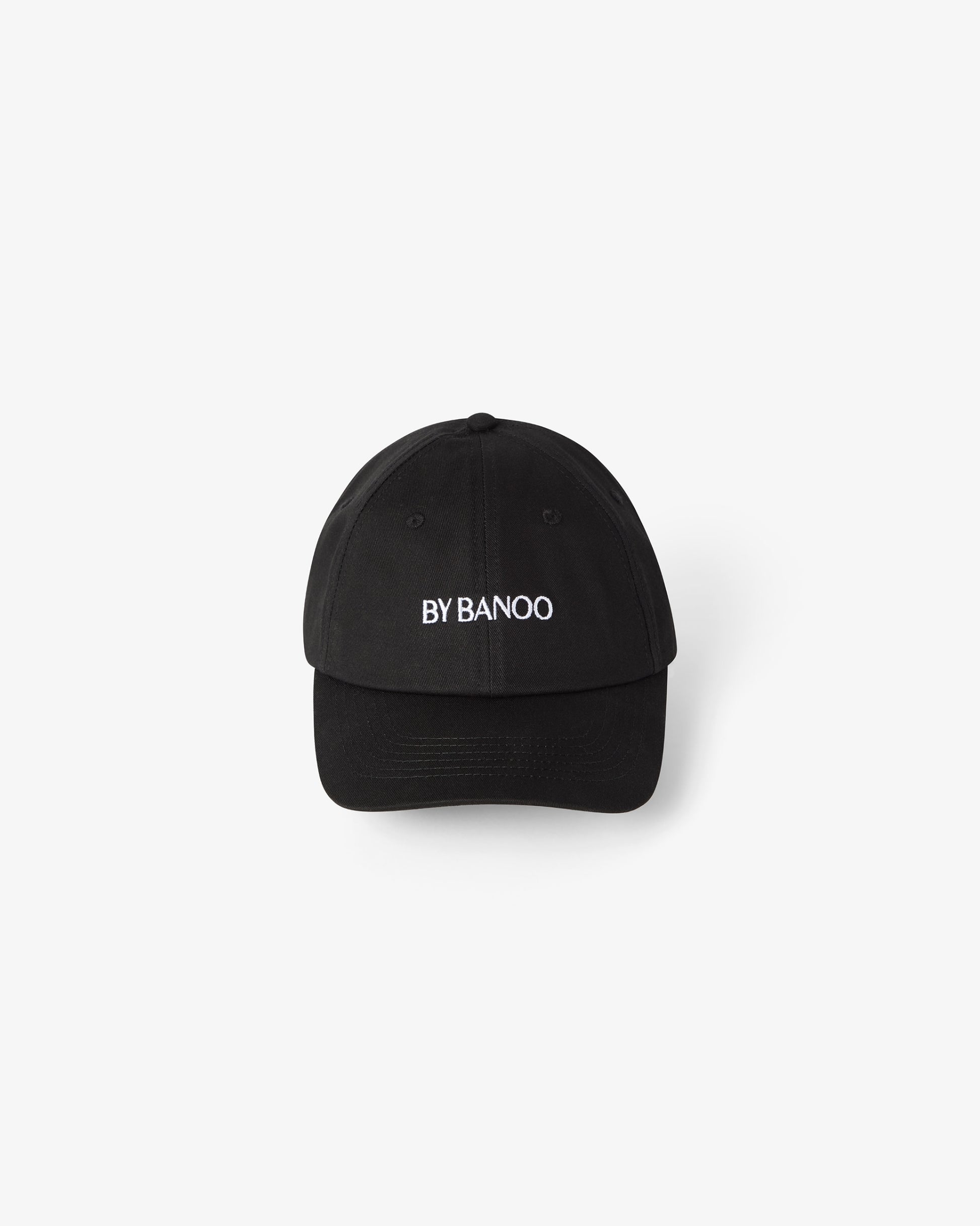 A black cotton cap with embroidered "BY BANOO" text.