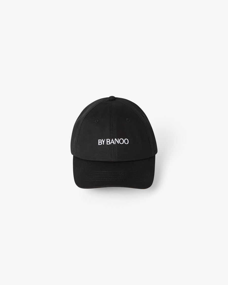 A black cotton cap with embroidered "BY BANOO" text.