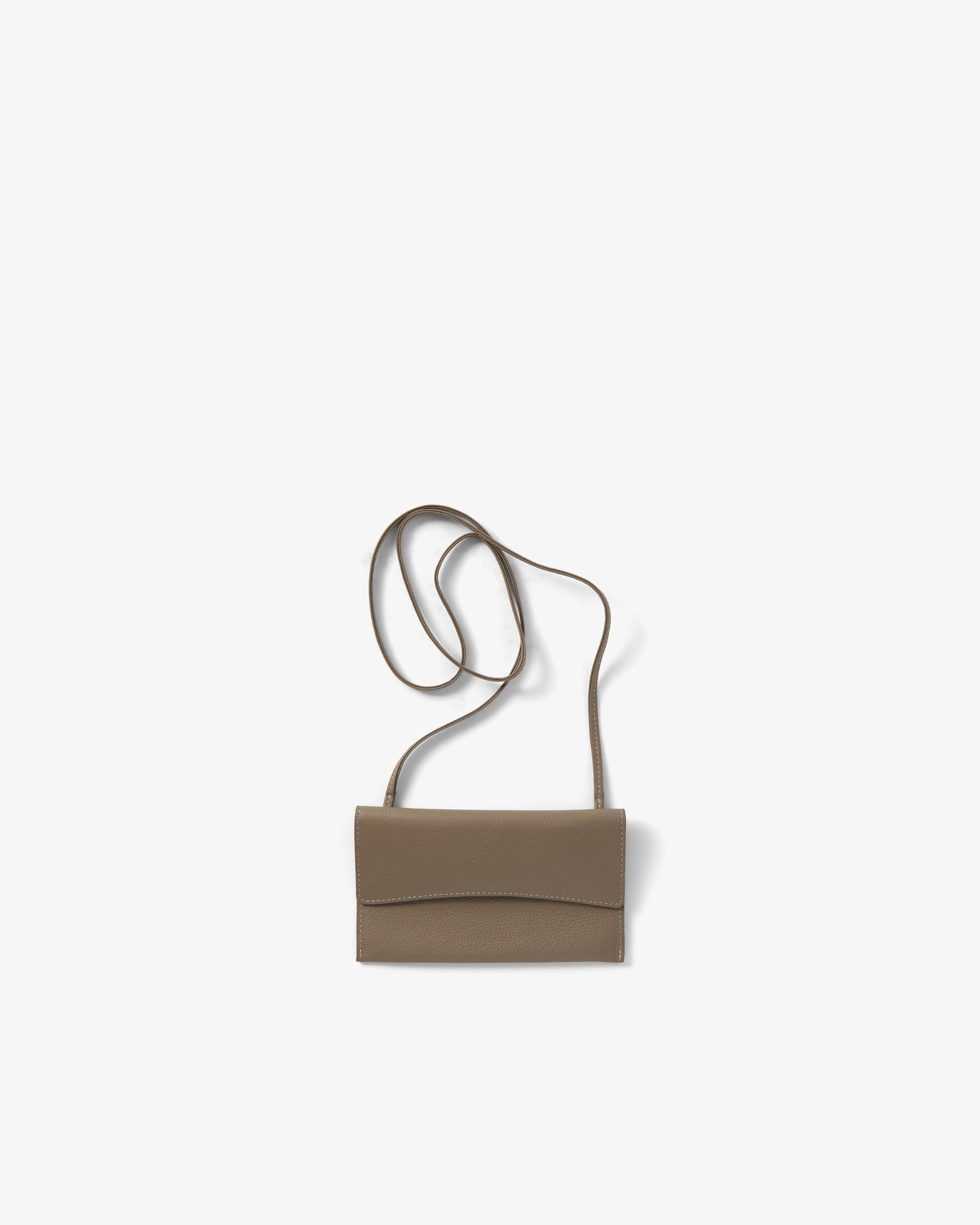A taupe leather crossbody bag, shown against a white, plain background.