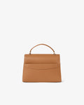 A structured tan leather handbag with a top handle and a luggage strap, shown from the back against a plain white background.