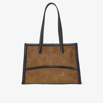 The Capacious Tote in the color Pecan/Gold. A structured suede and leather tote bag featuring elegant double handles and a curved exterior leather details. 
