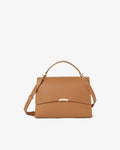 A tan leather handbag with a top handle, a detachable shoulder strap, and a small gold-tone metal accent on the front flap, shown against a plain white background.