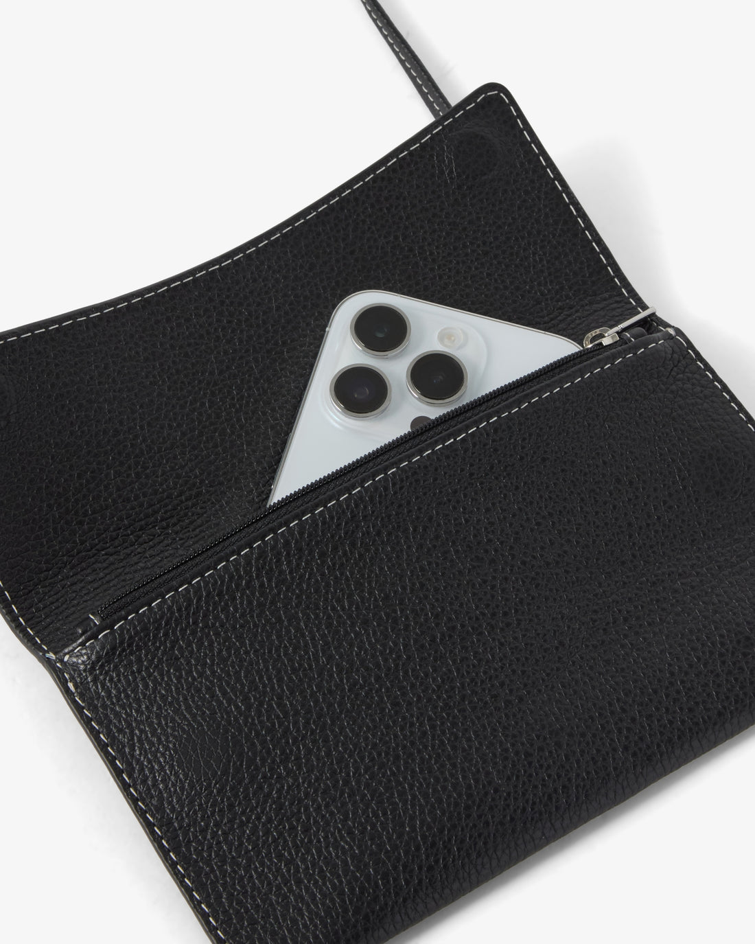 A black pebbled leather clutch shown open, with a silver smartphone partially tucked into the zip pocket. The product is photographed on a clean white background.