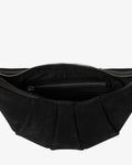 Close-up of the interior of a black pleated suede bag, showing a zippered compartment with a silver-tone zipper pull against a light gray background.