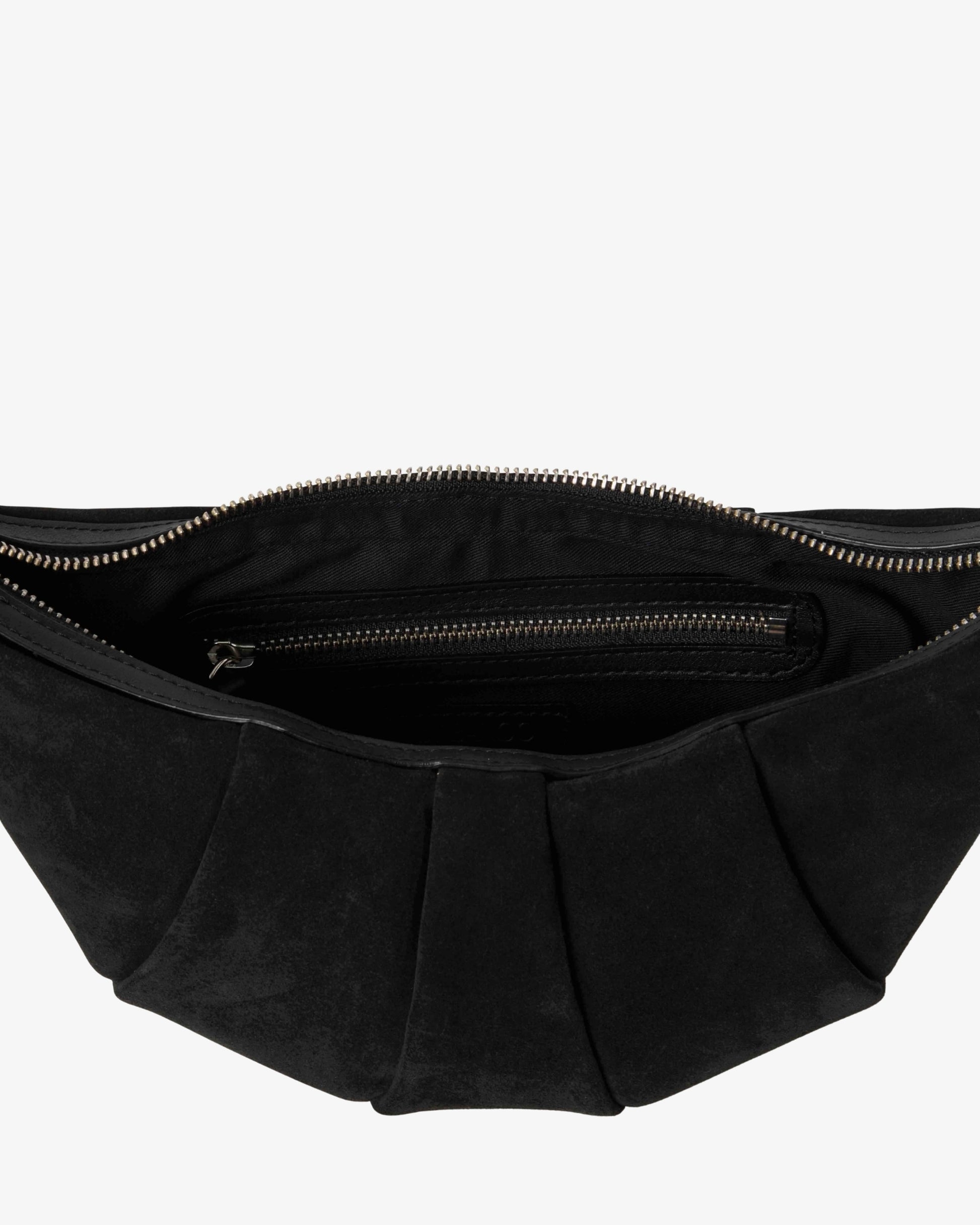 Close-up of the interior of a black pleated suede bag, showing a zippered compartment with a silver-tone zipper pull against a light gray background.