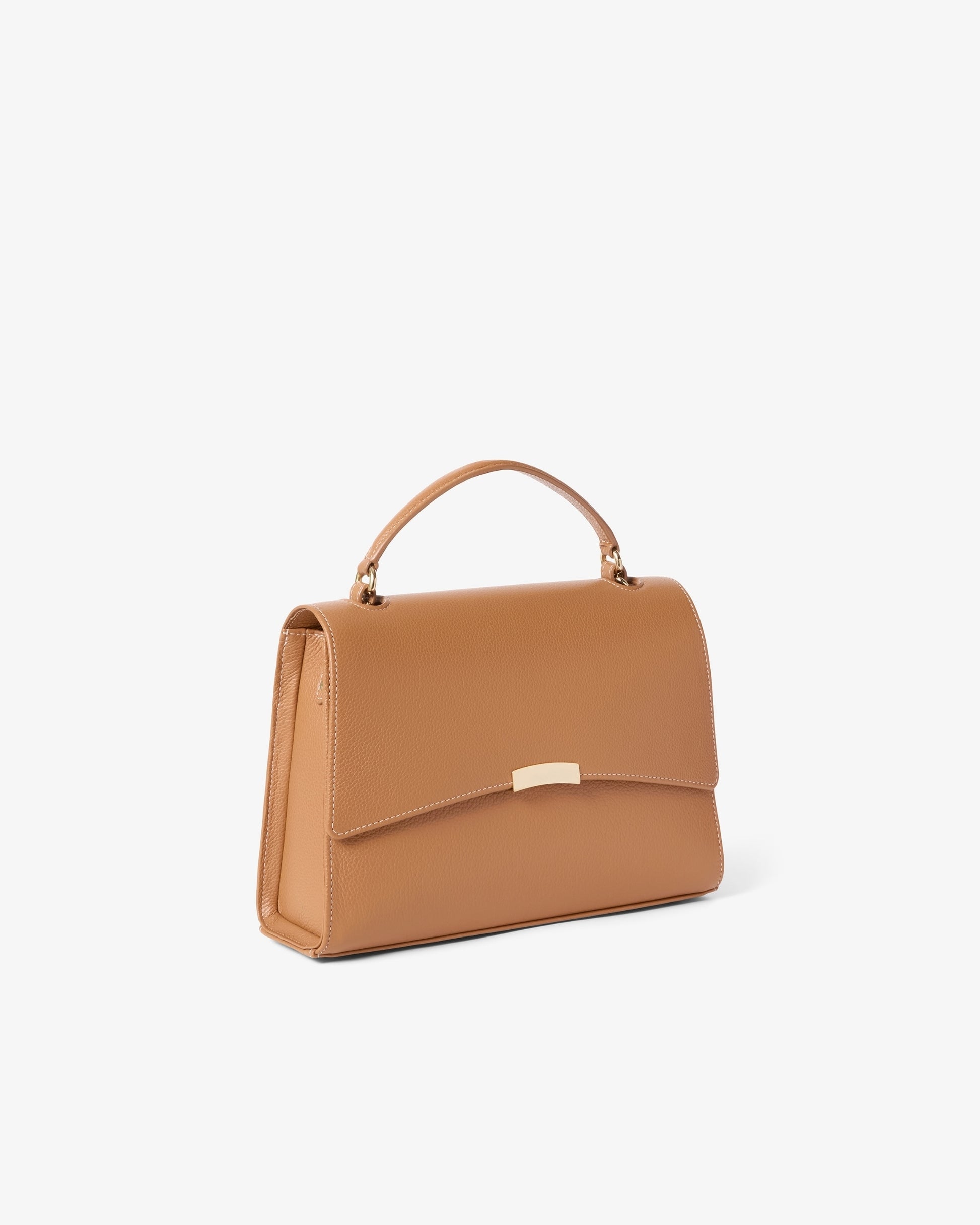 A structured tan leather handbag with a top handle and a small gold-tone metal accent on the front, shown against a plain light gray background.