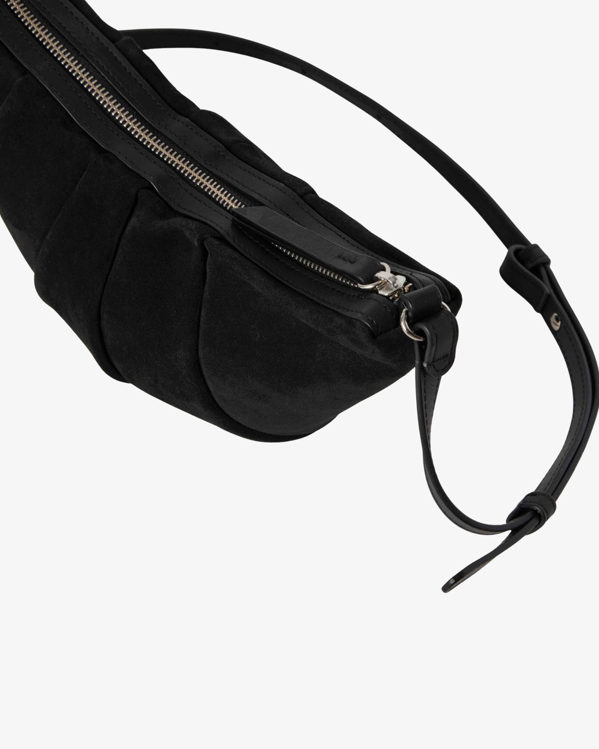 Close-up of a black textured shoulder bag with a silver zipper and a thin black strap, shown against a plain light gray background.
