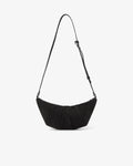 A black crescent-shaped shoulder bag made of textured suede, featuring a long thin shoulder strap and a pleated front design, shown against a plain white background.