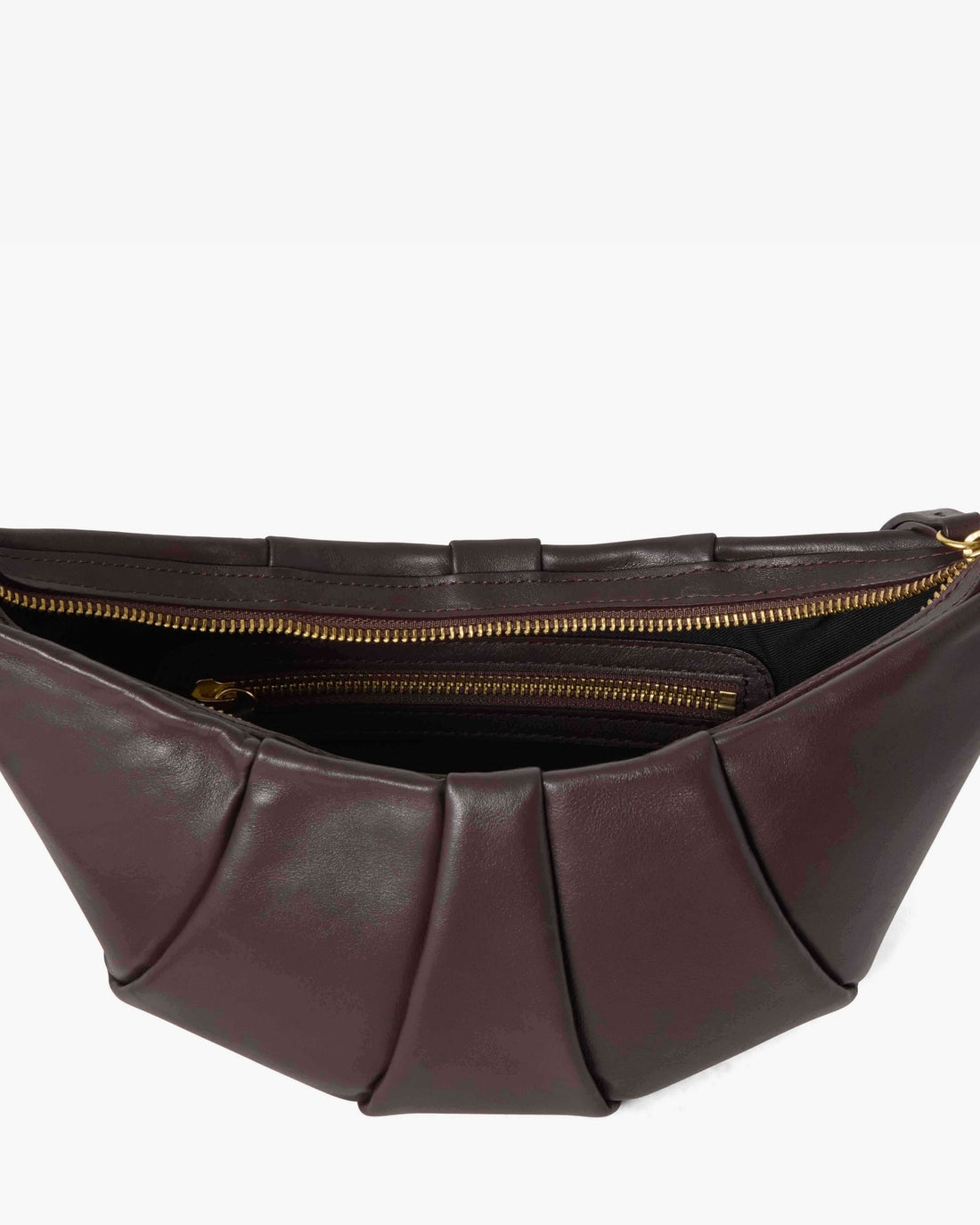 A close-up of a pleated leather bag in dark  brown, showing the interior with gold zippers against a light gray background.