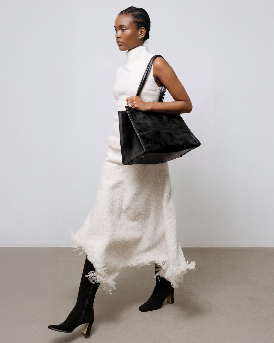 A black tote bag with a matte finish and double shoulder straps, shown against a plain white background.