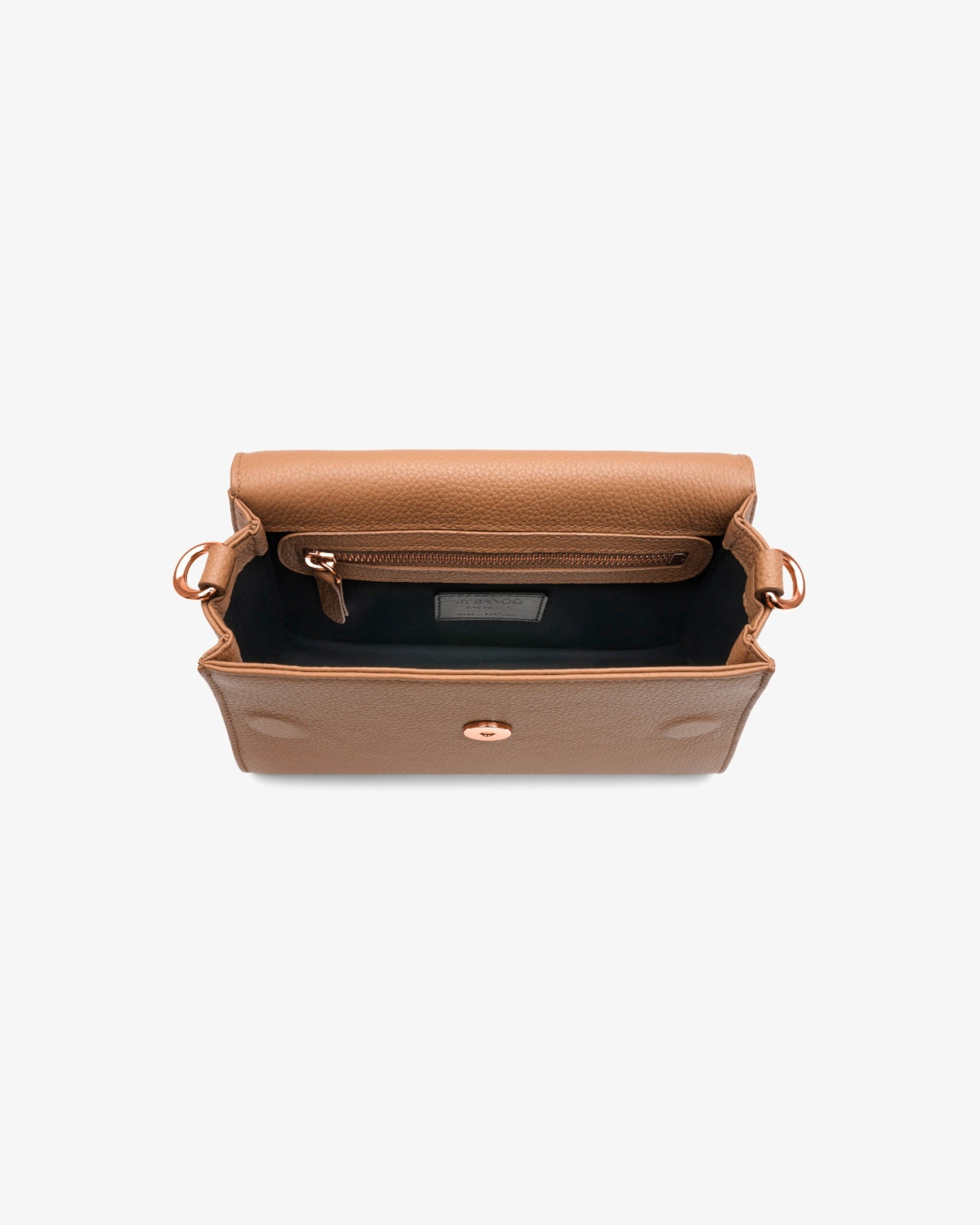 Top-down view of a tan leather clutch bag with a black interior lining and gold-tone hardware, shown on a light gray background.