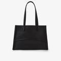 The Capacious Tote (Black/Silver) in smooth black leather showcasing its structured and elegant silhouette.