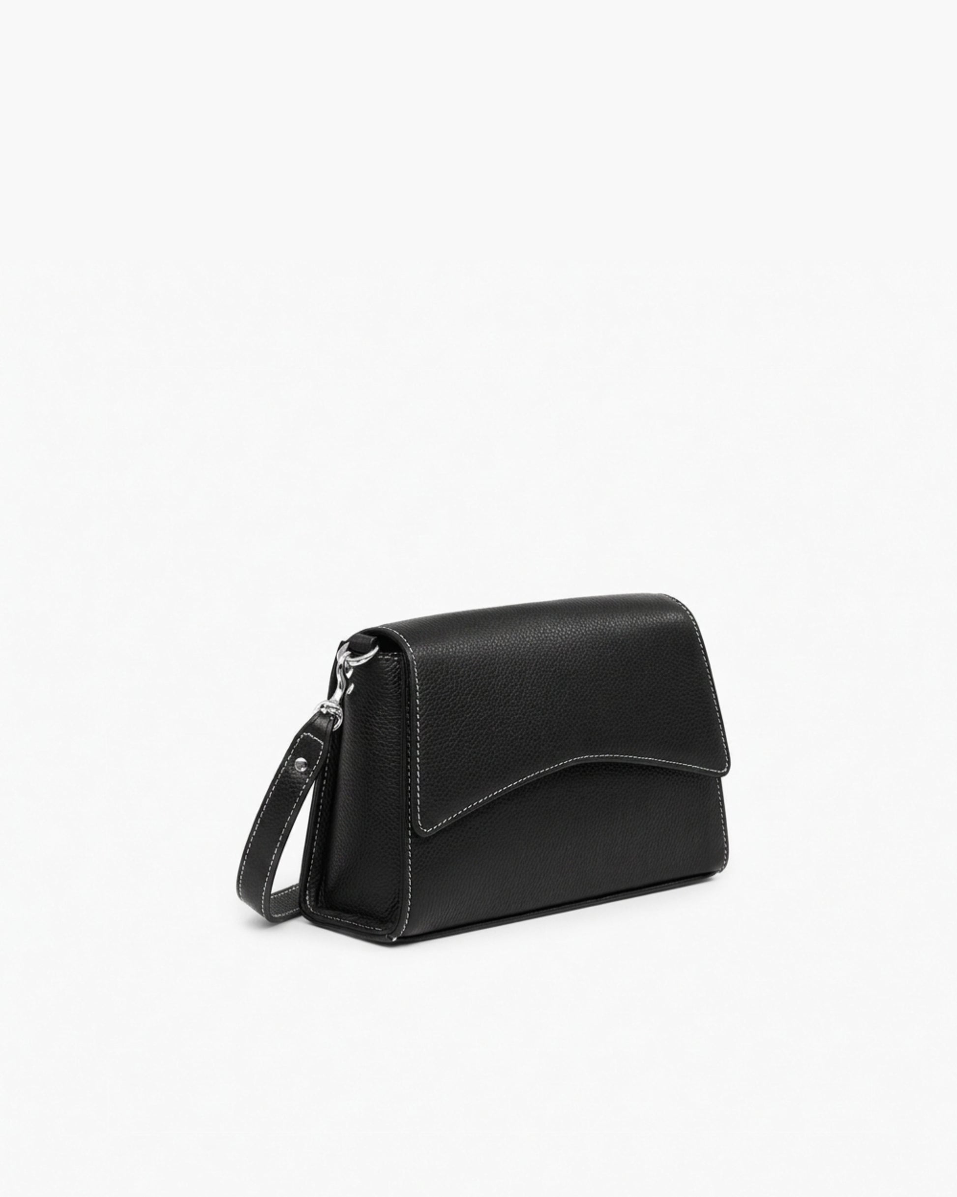 A black pebbled leather crossbody bag with a cross body strap and silver hardware, photographed on a clean white background.