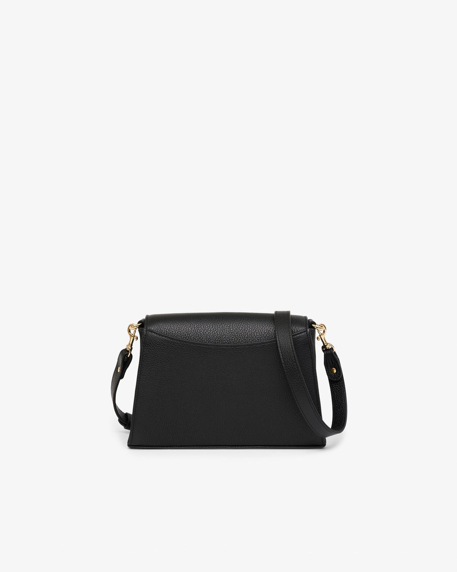 Black leather handbag with gold hardware and a detachable cross body strap, shown from the back in front of a white background. 
