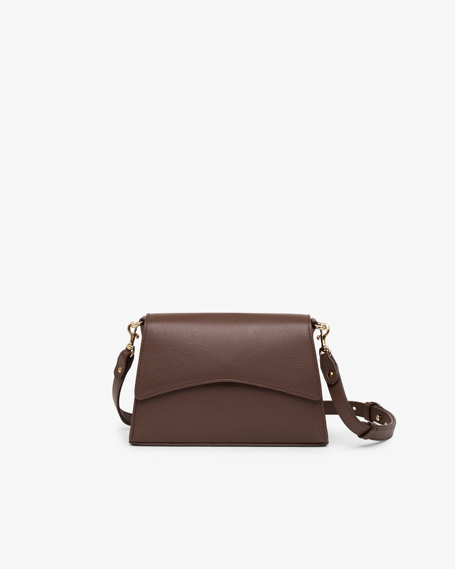 A dark brown leather crossbody bag with a flap closure and a thin shoulder strap, shown against a plain white background.