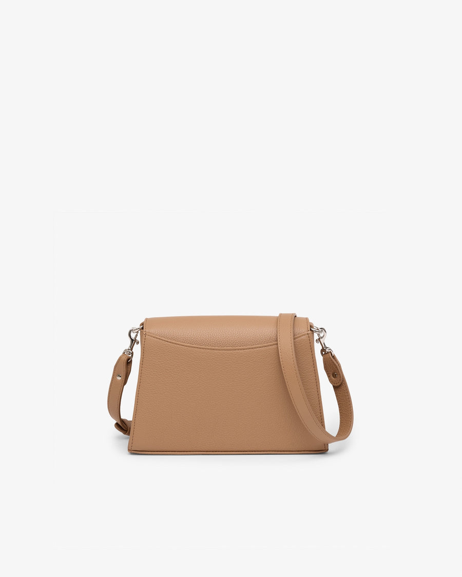 A structured tan leather crossbody bag with a curved top flap and a matching shoulder strap, shown against a plain white background.