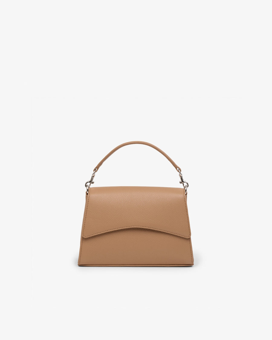 A structured tan leather handbag with a top handle and a curved flap, shown against a plain white background.