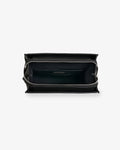 An empty black leather backpack, revealing the black interior lining and inner pockets.