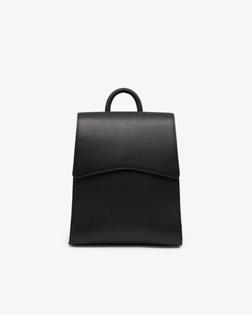 A minimalist black leather backpack with a top handle, shown from the front against a clean white background.