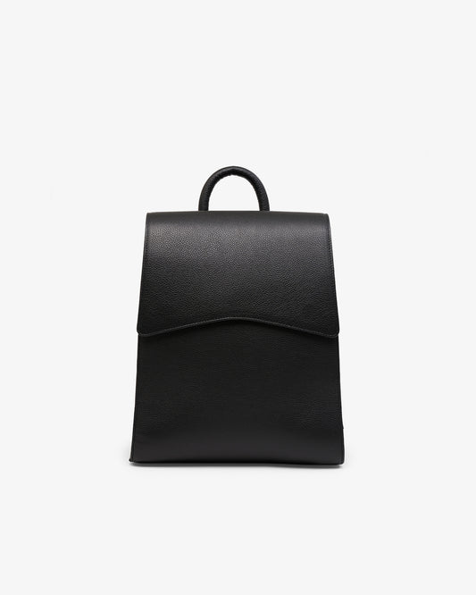 A minimalist black leather backpack with a top handle, shown from the front against a clean white background.