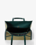 An open dark green leather tote bag with beige panels, shown from the back against a light gray background.
