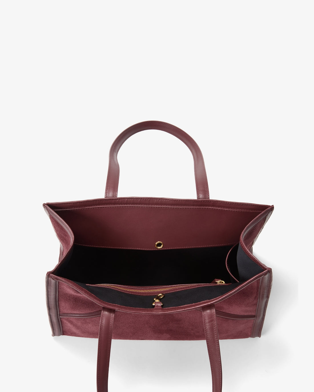 A top-down view of a burgundy leather tote bag with a black interior lining and gold-tone hardware, set against a plain white background.