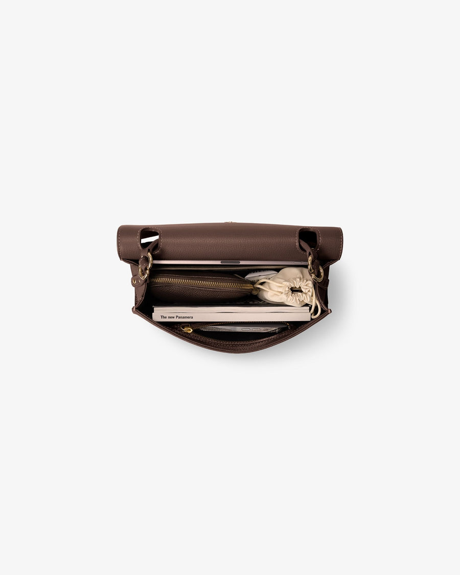 A brown leather clutch bag shown open from a top-down view, containing a matching brown zippered pouch, a black pen holder, and a white clutch insert.