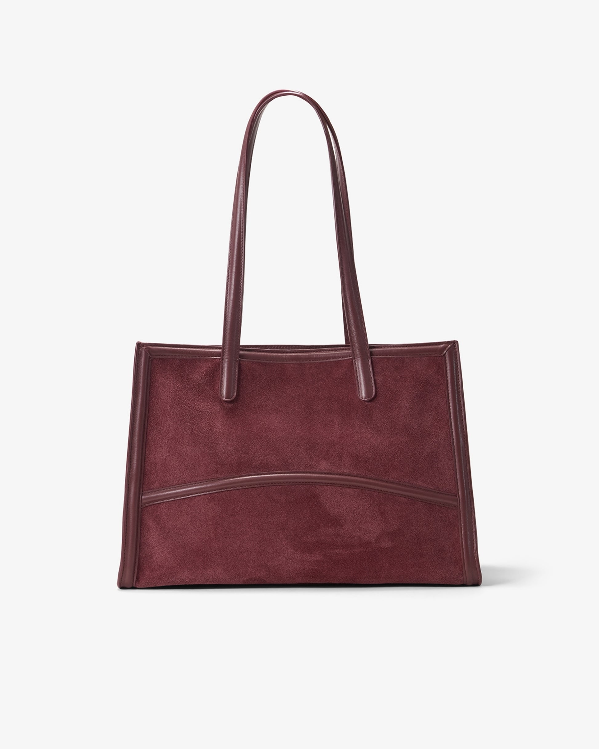 A dark burgundy suede tote bag with smooth leather handles and trim, shown against a plain light gray background.