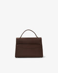 A dark brown leather handbag with a structured rectangular shape, a top handle, and a luggage strap, shown from the back against a plain white background.