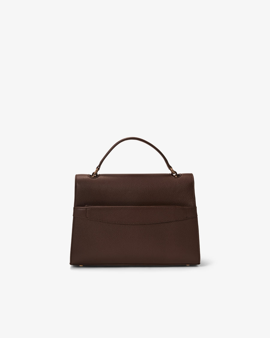 A dark brown leather handbag with a structured rectangular shape, a top handle, and a luggage strap, shown from the back against a plain white background.