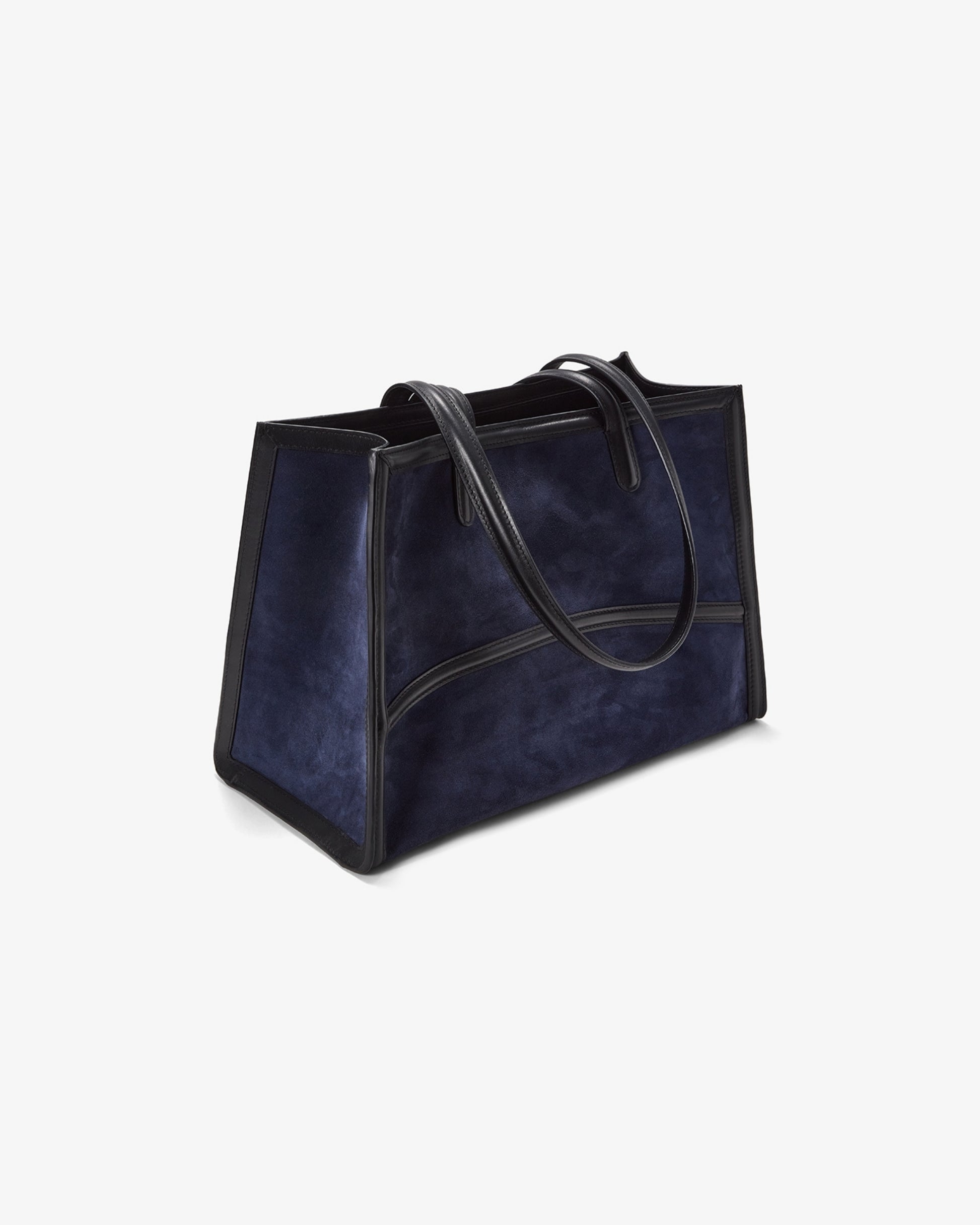 A navy blue suede tote bag with black leather trim and handles, shown from a three-quarters angle on a light gray background.