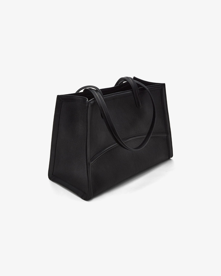A black leather tote bag with double shoulder straps, shown from a three-quarters perspective on a clean white background.