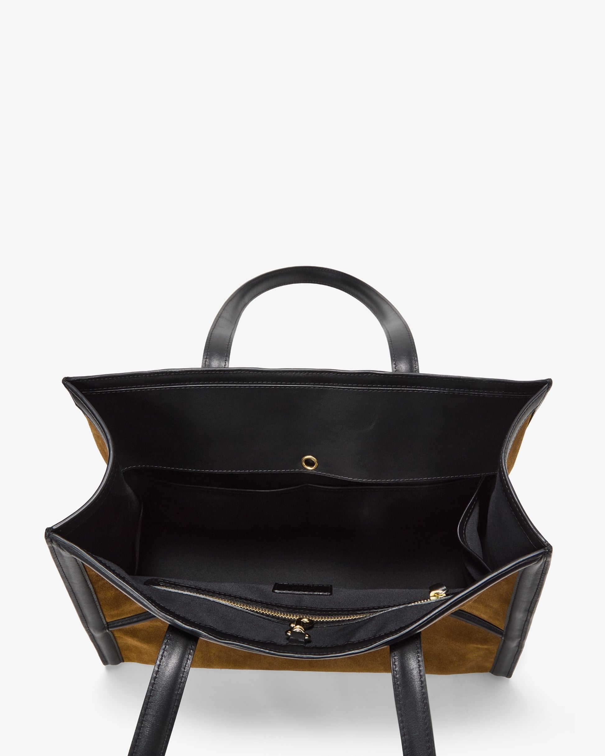 An overhead view of a structured tote bag with a black interior lining, black leather handles, and tan and black striped exterior panels, shown against a plain white background.