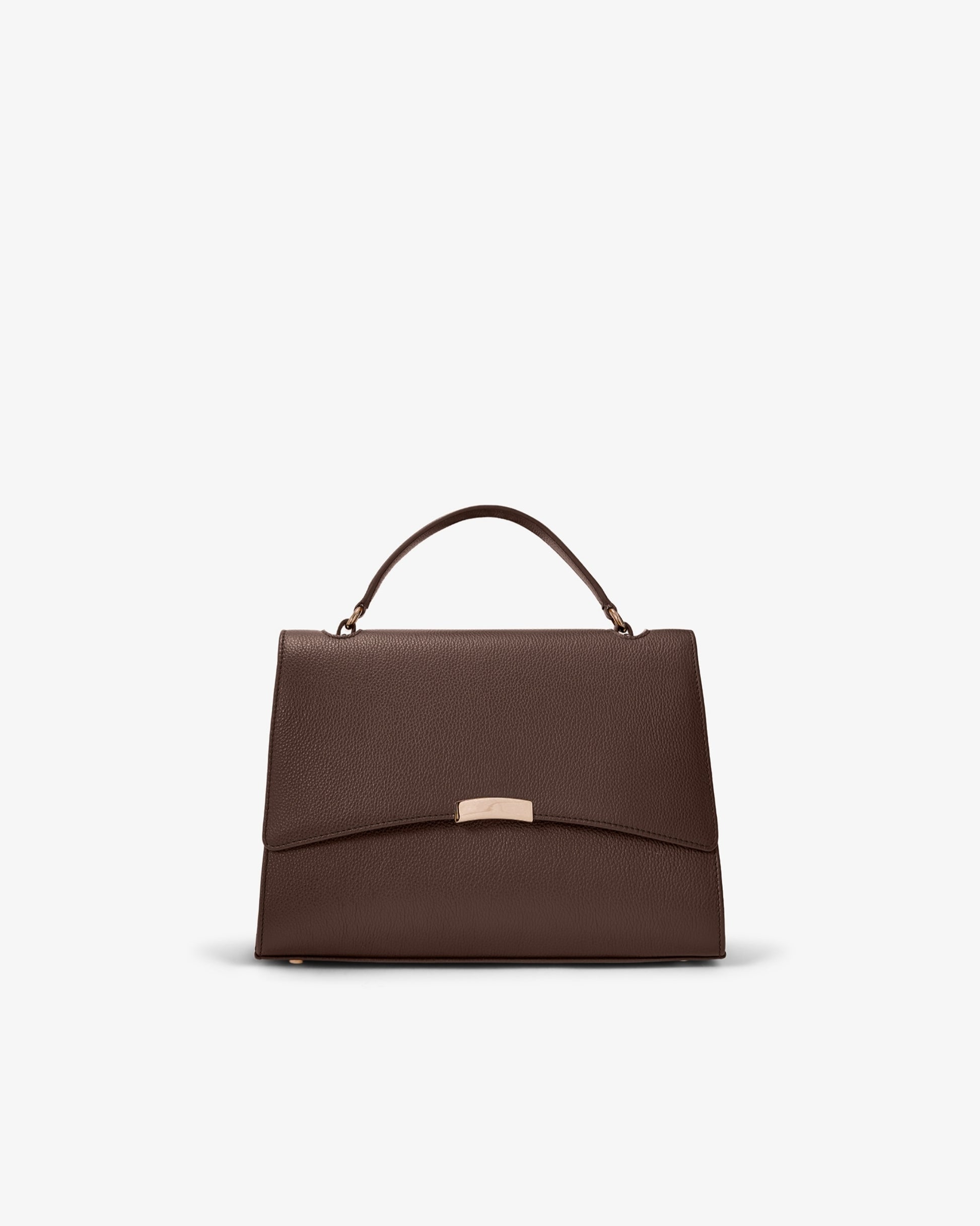 A structured dark brown leather handbag with a top handle and a small gold-tone metal accent on the front flap, shown against a plain light gray background.
