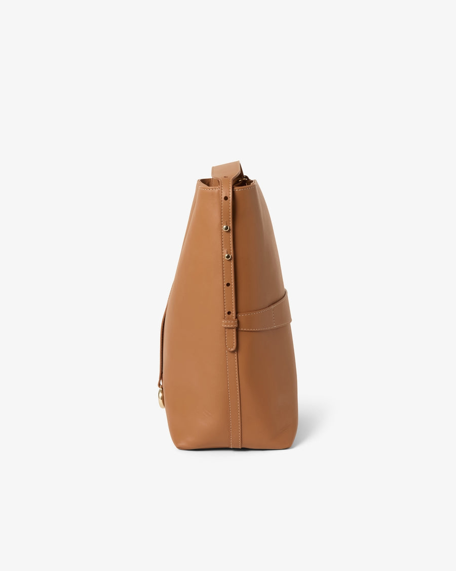 A tan leather shoulder bag shown from a side profile view against a clean white background.