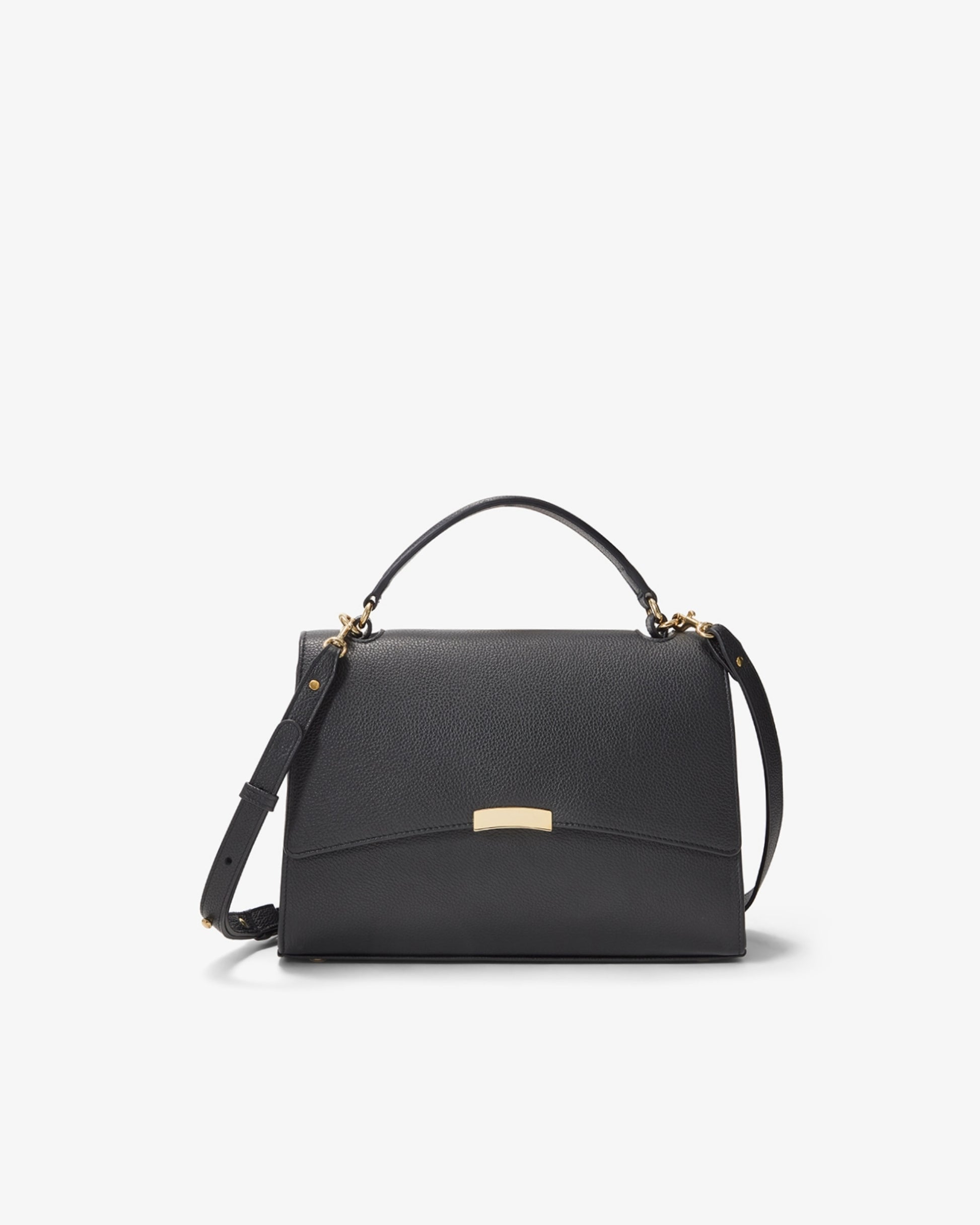 A black textured leather handbag with a top handle, a detachable shoulder strap, and a small gold-tone metal plaque on the front flap, shown against a plain white background.