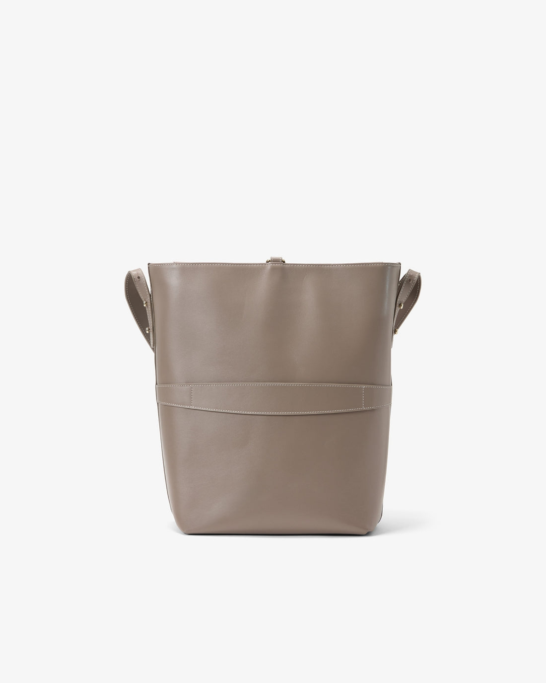 A taupe leather bucket bag with integrated side handles and a horizontal luggage strap, shown from the back against a plain white background.