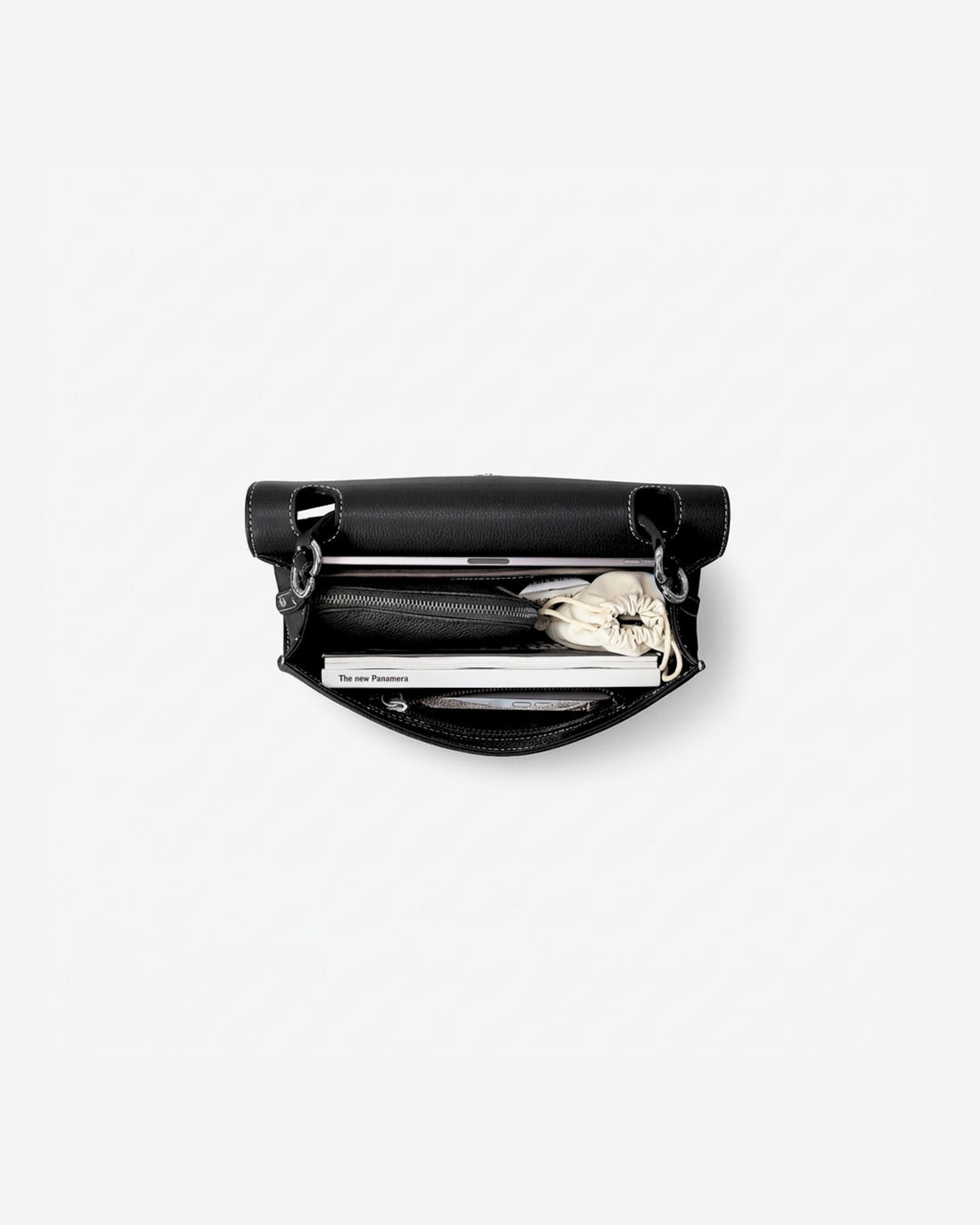A black leather zippered briefcase shown open from a top-down view, revealing an iPad, a cable pocket and other small accessories inside, set against a plain white background.