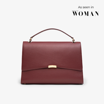 Signature Briefcase in burgundy/gold with structured silhouette and gold hardware – elegant work bag crafted from premium pebbled leather.