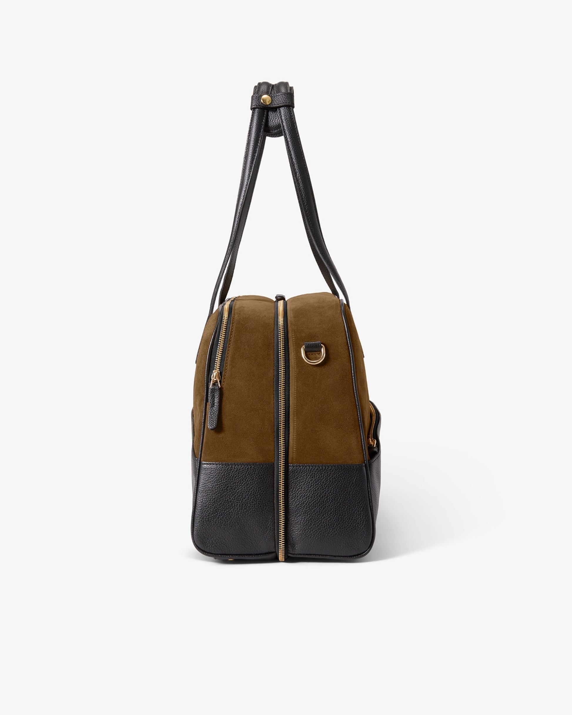 A structured duffel bag with a two-tone color-blocked design, featuring a brown suede upper section and a black leather lower section and shoulder strap, shown against a plain light gray background.