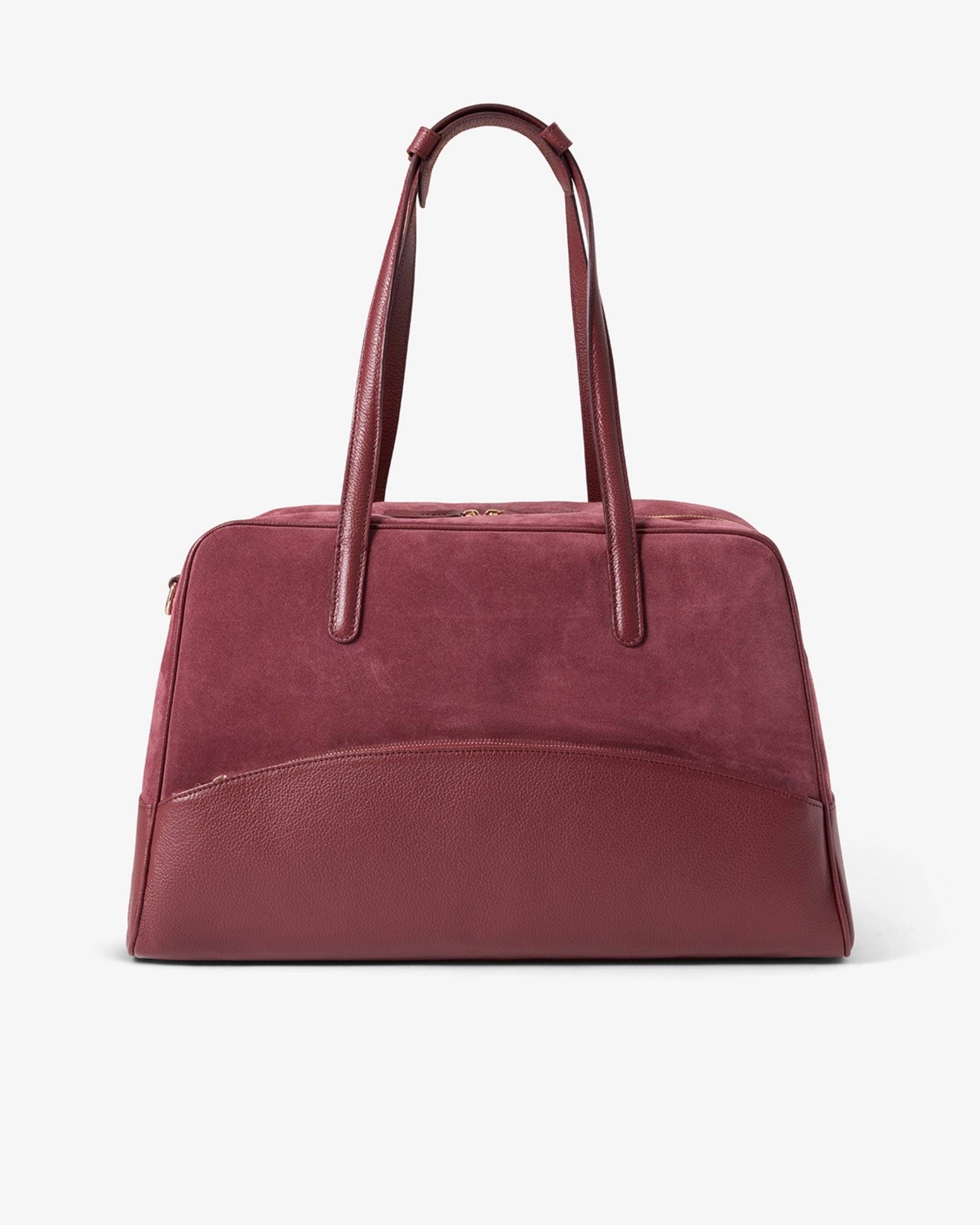 A burgundy leather handbag with dual top handles and a curved front pocket, photographed against a clean white background.