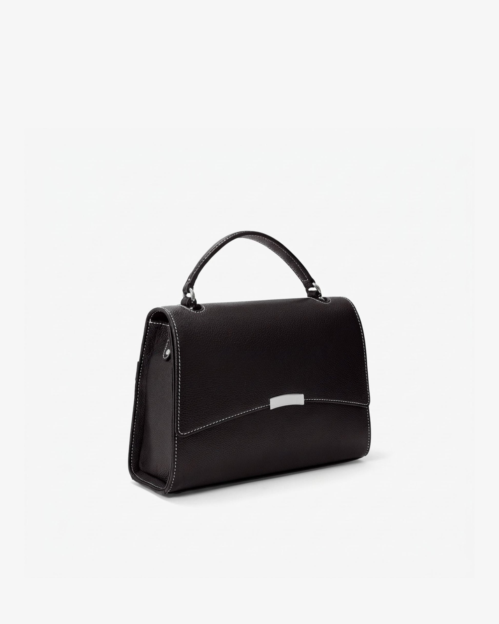 A black leather top-handle handbag with a silver-tone metal accent on the front flap, shown from a three-quarter angle against a plain white background.