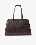 A dark brown crocodile-embossed leather handbag with dual top handles and a luggage strap, shown from the back against a plain light gray background.