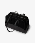 A black duffel bag made of leather and suede, with dual top handles and a shoulder strap, photographed on a clean white background.