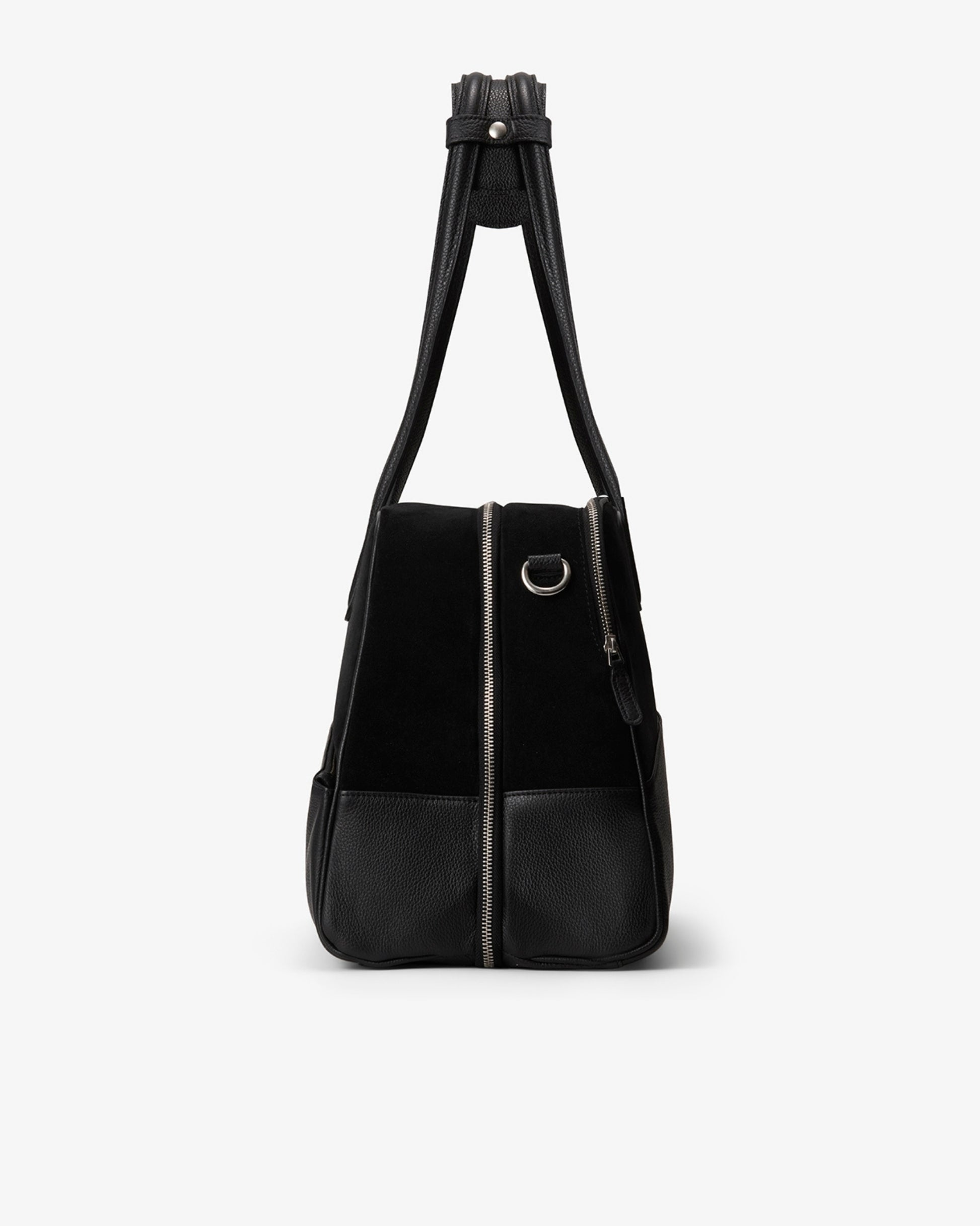 A black shoulder bag with a black suede upper body, black leather lower front pocket, and a black shoulder strap, shown against a plain white background.