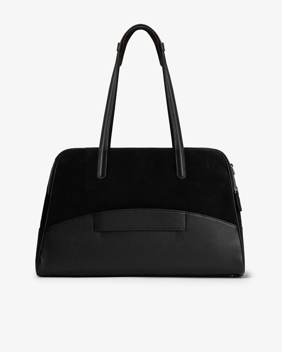 A black leather and suede handbag with dual top handles, a structured dome shape, and a luggage strap, shown from the back against a plain white background.