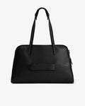 A black textured leather handbag with double top handles and a luggage strap, shown from the back against a plain white background.
