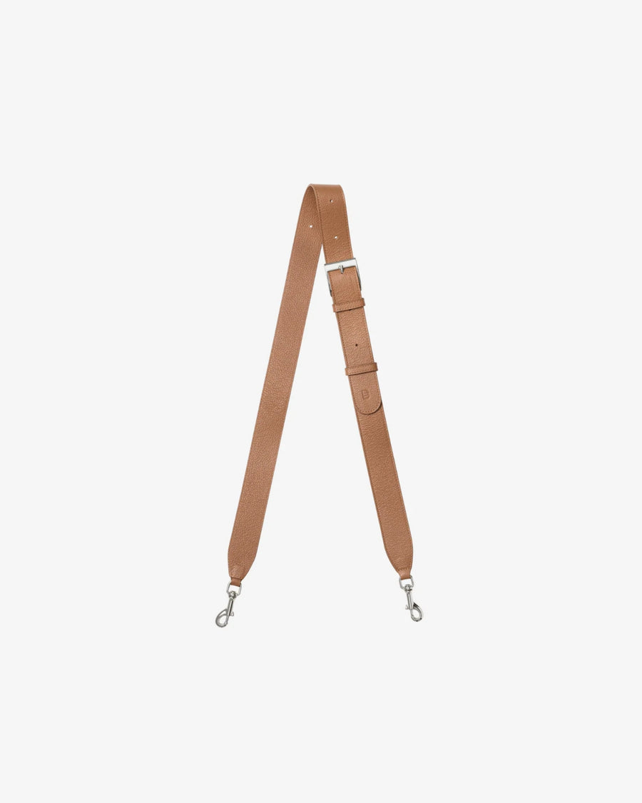 A tan leather shoulder strap with silver metal swivel clips on both ends, displayed vertically against a solid off-white background.