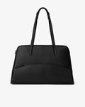 A black pebbled leather handbag with dual top handles and a curved front pocket, shown against a plain white background.