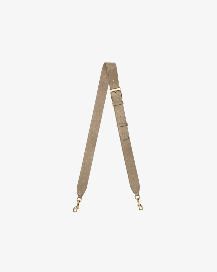 A taupe leather shoulder strap with gold-tone metal hardware, including a buckle, adjustment loops, and two swivel snap hooks, displayed on a light gray background.